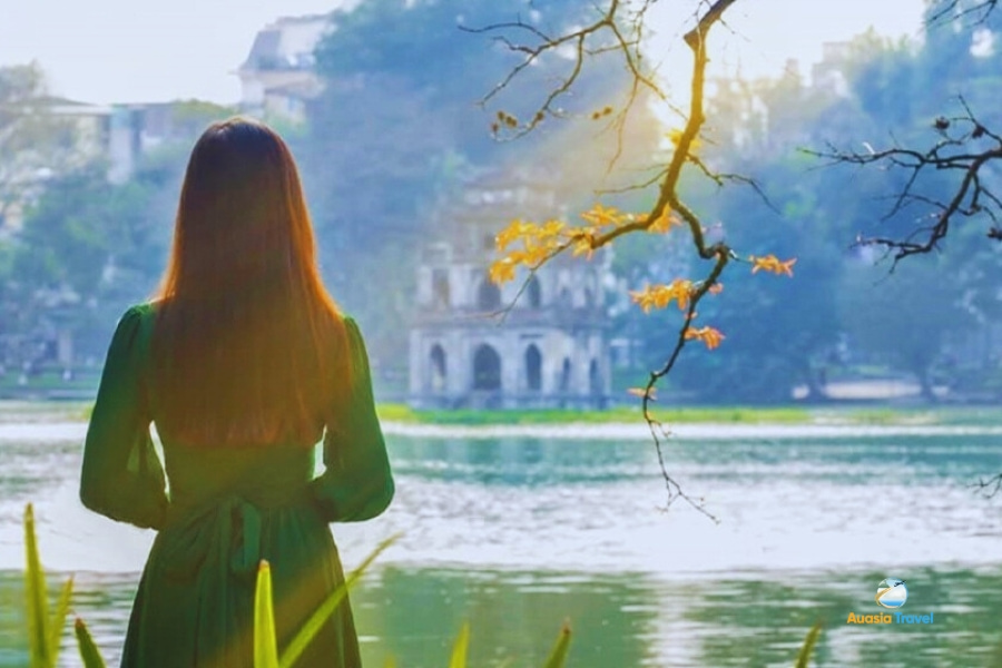 Hoan Kiem lake in old quarter, Hanoi reflecting ancient trees and historic temples
